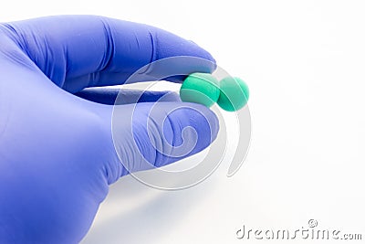 Doctor or scientist holds in his gloved hand biological 3D model diplococci bacteria in form of two joined cells. Visualization of Stock Photo