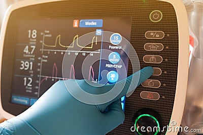 A doctor setting mechanical ventilator for patient in hospital Stock Photo