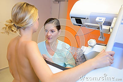 Doctor setting patient in correct position for mammogram Stock Photo