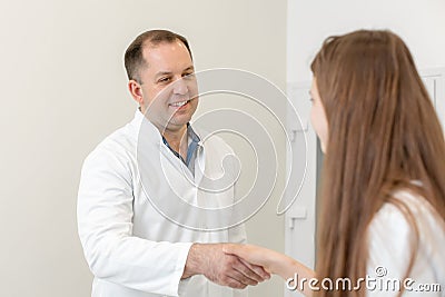 The doctor shakes hands with the patient Editorial Stock Photo