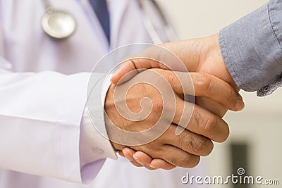 Doctor shakes hands with a patient Stock Photo