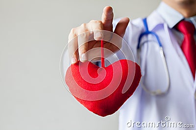 Doctor showing compassion and support holding red heart Stock Photo
