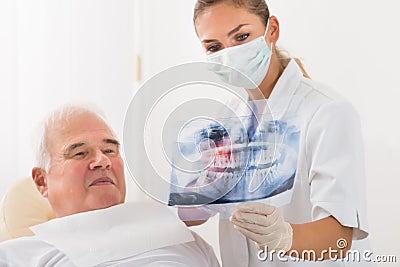 Doctor Showing Dental X-ray To Male Patient Stock Photo