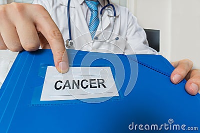 Doctor is showing folder with cancer diagnosis Stock Photo