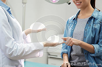 Doctor showing silicone implants for breast augmentation Stock Photo