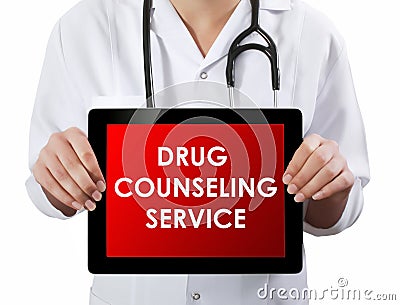 Doctor showing tablet with DRUG COUNSELING SERVICE text. Stock Photo