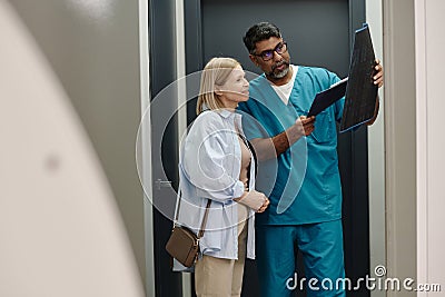 Doctor Showing X-ray Image To Happy Patient Stock Photo