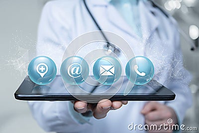 Doctor shows contacts icons on a tablet Stock Photo