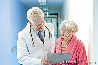 Doctor Shows Female Elderly Patient Results. Stock Photo