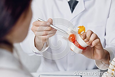 Doctor shows intervertebral hernia to a patient Stock Photo