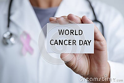 Doctor and signboard with text world cancer day Stock Photo