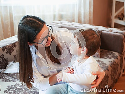 A doctor and a small child. first meeting with a doctor. doctor at home. call at the address Stock Photo