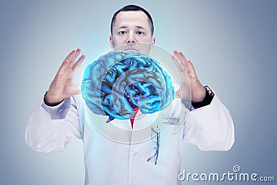 Doctor with stethoscope and brains on the hands. gray background. High resolution. Stock Photo