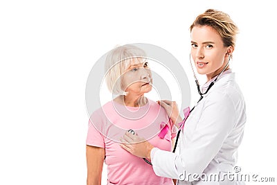 doctor with stethoscope checking health of senior woman and looking at camera Stock Photo