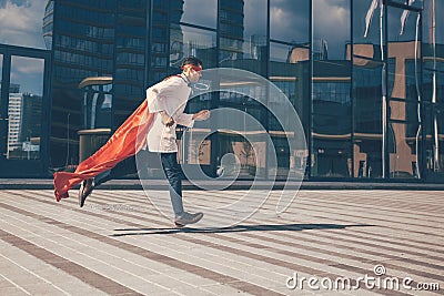 Doctor is a superhero running through the city streets. Stock Photo