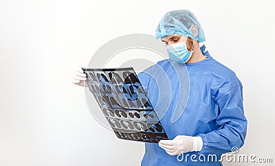 Doctor surgeon in protective uniform check up x ray film of lungs scan. Coronavirus Covid 19, pneumonia, tuberculosis, lung cancer Stock Photo