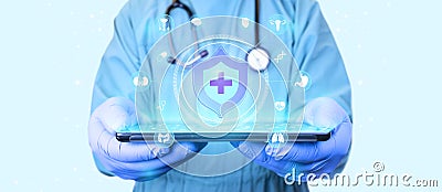 Doctor with tablet shows health insurance icon. Stock Photo