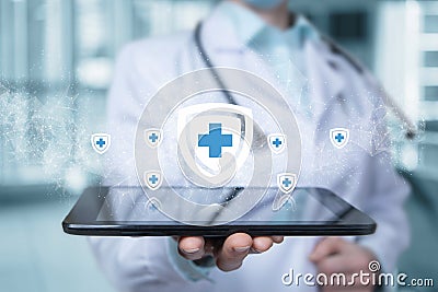 Doctor on the tablet shows the system of medical protection Stock Photo