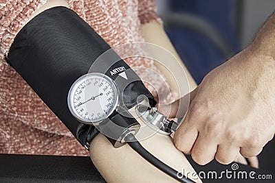 Doctor taking blood pressure Stock Photo