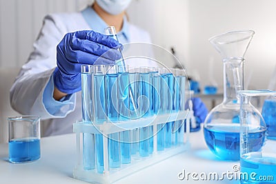 Doctor taking test tube with blue liquid. Laboratory analysis Stock Photo