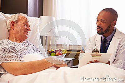 Doctor Talking To Senior Male Patient In Hospital Bed Stock Photo