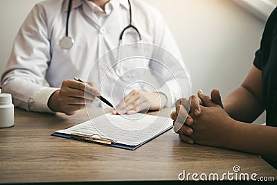 Doctor talking to a senior patient in a clinic Stock Photo