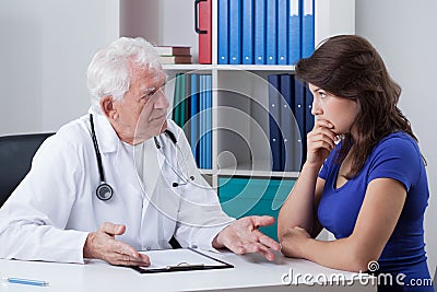 Doctor talking with worried patient Stock Photo