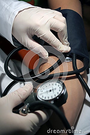 Doctor testing blood pressure Stock Photo