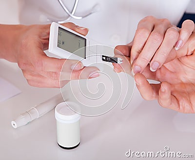 Doctor testing a patients glucose level Stock Photo