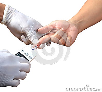 Doctor testing a patients glucose level after pricking his finger to draw a drop of blood and then using a digital glucometer in Stock Photo