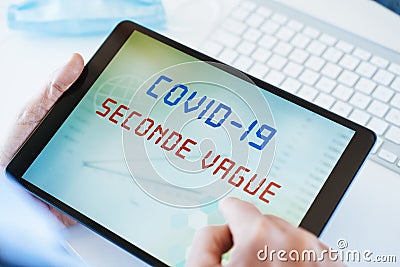 Doctor and text covid-19 second wave in french Stock Photo