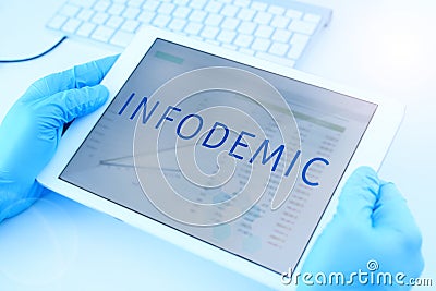 Doctor and the text infodemic in a tablet Stock Photo