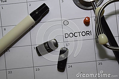 Doctor text on white calendar background. Reminder or schedule concept Stock Photo