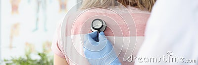 Doctor therapist listens to patient breathing with stethoscope Stock Photo