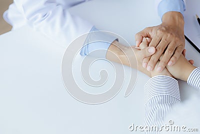 Doctor touches the arm to encourage the patient in the hospital examination room, treating the disease from a medical professional Stock Photo