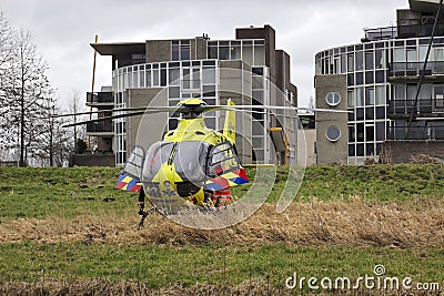 Doctor from trauma helicopter helps ambulance personnel with injured child after collision in Nieuwerkerk aan den IJssel Editorial Stock Photo