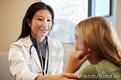 Doctor Treating Teenage Girl Suffering With Depression Stock Photo