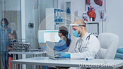 Doctor typing the treatment on laptop Stock Photo