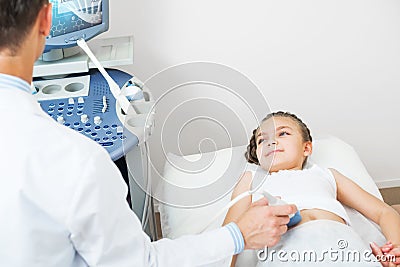 Doctor ultrasound examines little girl belly Stock Photo