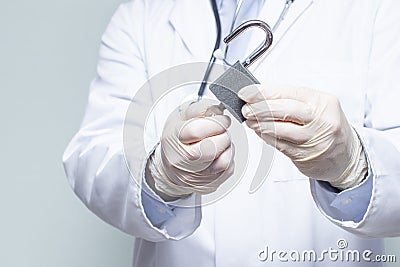 A doctor unlocking the padlock during a pandemic Stock Photo