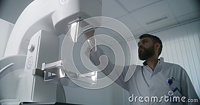 Doctor uses computer, then sets up mammogram scanning machine Editorial Stock Photo