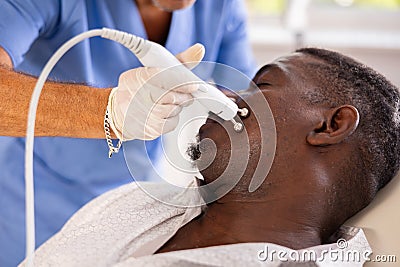 Doctor uses RF-lifting beauty machine nozzle for stimulate collagen production Stock Photo