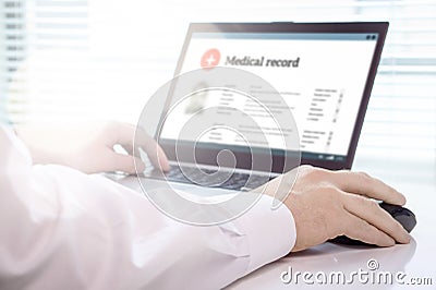 Doctor using laptop and electronic medical record EMR system. Stock Photo