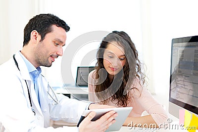 Doctor using tablet to inform patient Stock Photo