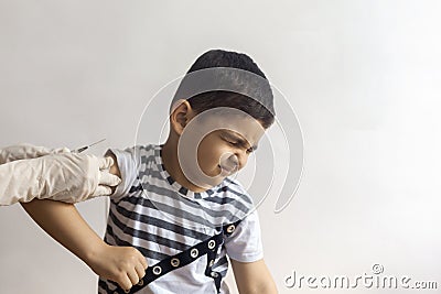 A doctor vaccinating young patient. Little boy scared of injection Stock Photo