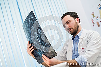 Doctor viewing mri x-ray of brain in office Stock Photo