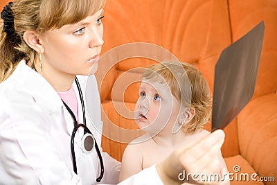 Doctor visit baby and looking at an x-ray Stock Photo