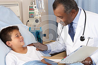 Doctor Visiting Child Patient On Ward Stock Photo