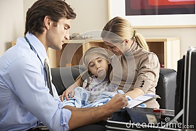 Doctor visiting sick child and mother at home Stock Photo