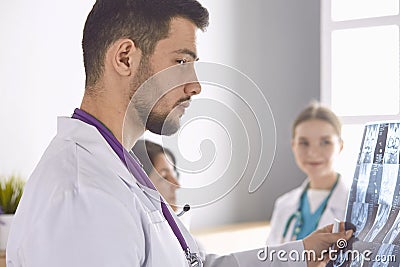 Doctor watching x-ray photography of elder woman Stock Photo